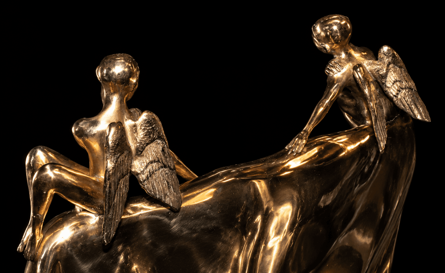 Golden_Angel_Sculptures_on_a_Reflective_Ledge.png